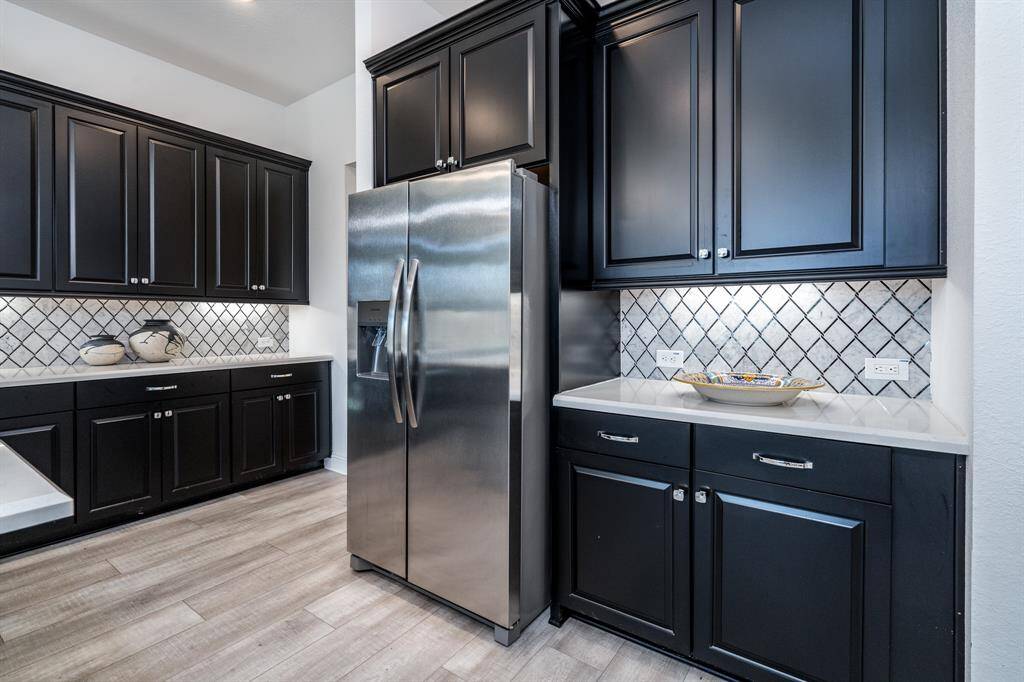 The stainless side by side fridge and backsplash detail.