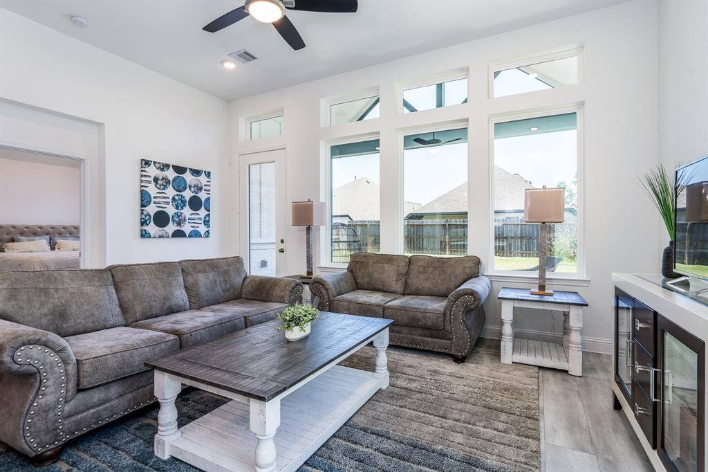 With tall ceilings and lots of windows, this living room is the heart of the home.  The primary bedroom is to the left on the first floor.