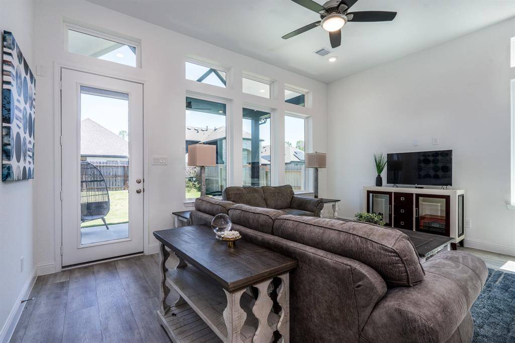 Another view of the living room looking out to the backyard and covered patio.