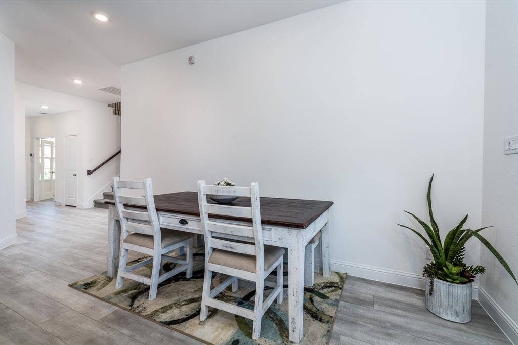 The dining area can fit a larger table with room for 8 or more.