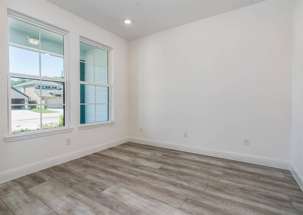 Replete with glass French doors, this office overlooks the front yard.