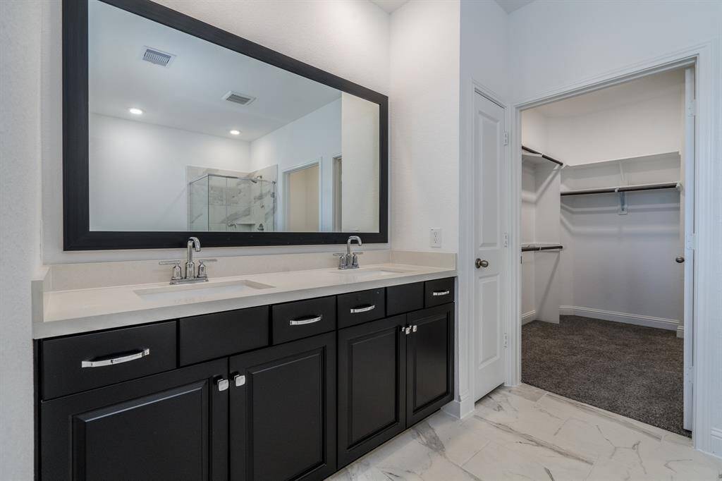 Dual vanities and a large walk in closet welcome you.