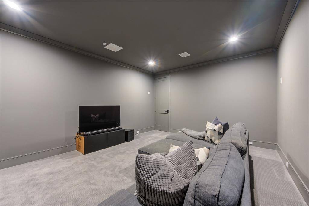 Experience ultimate entertainment in this sleek media room, perfect for movie nights and gaming.