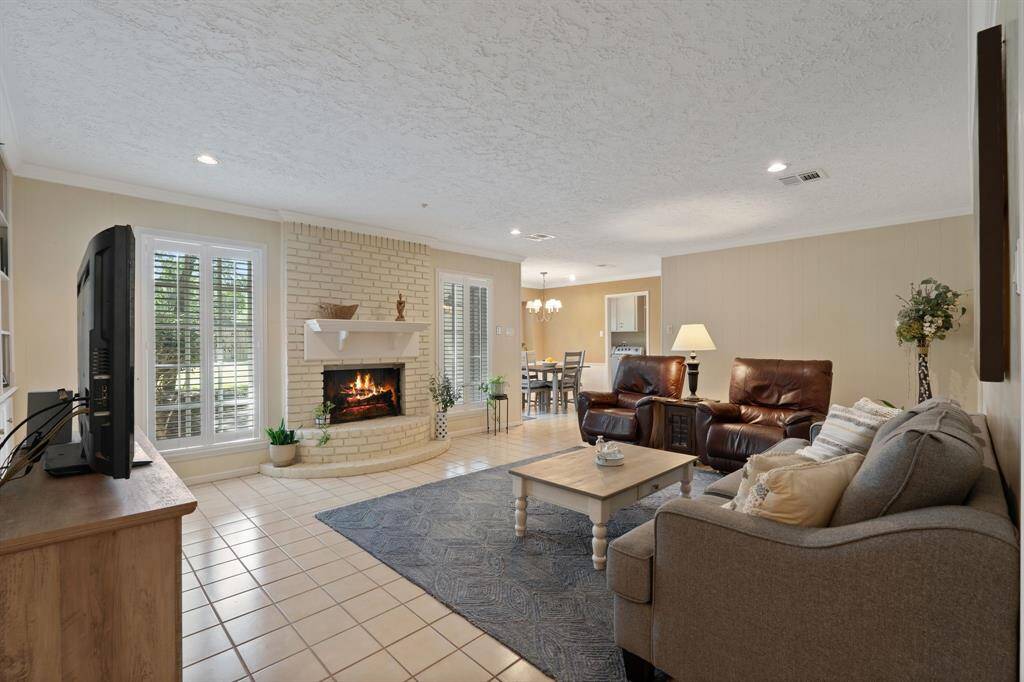 Beautiful open family room with a wood-burning fireplace.
