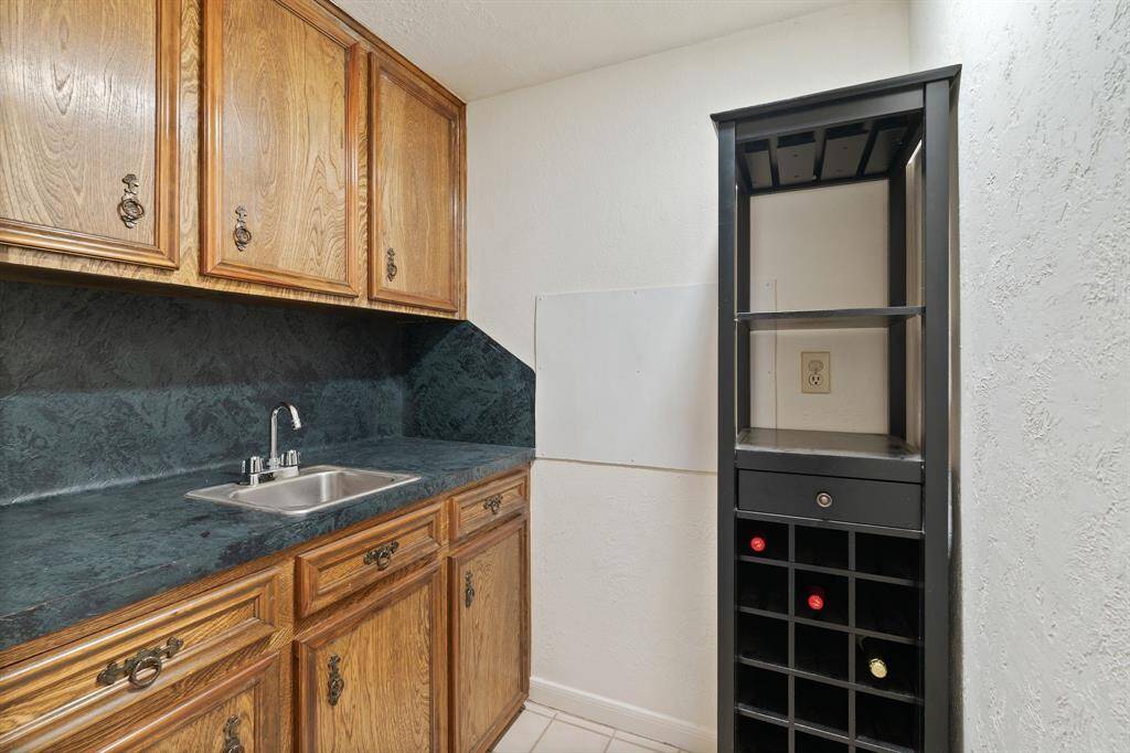 Located in the hall way between the family room and primary bedroom is a wet bar closet. So much storage!