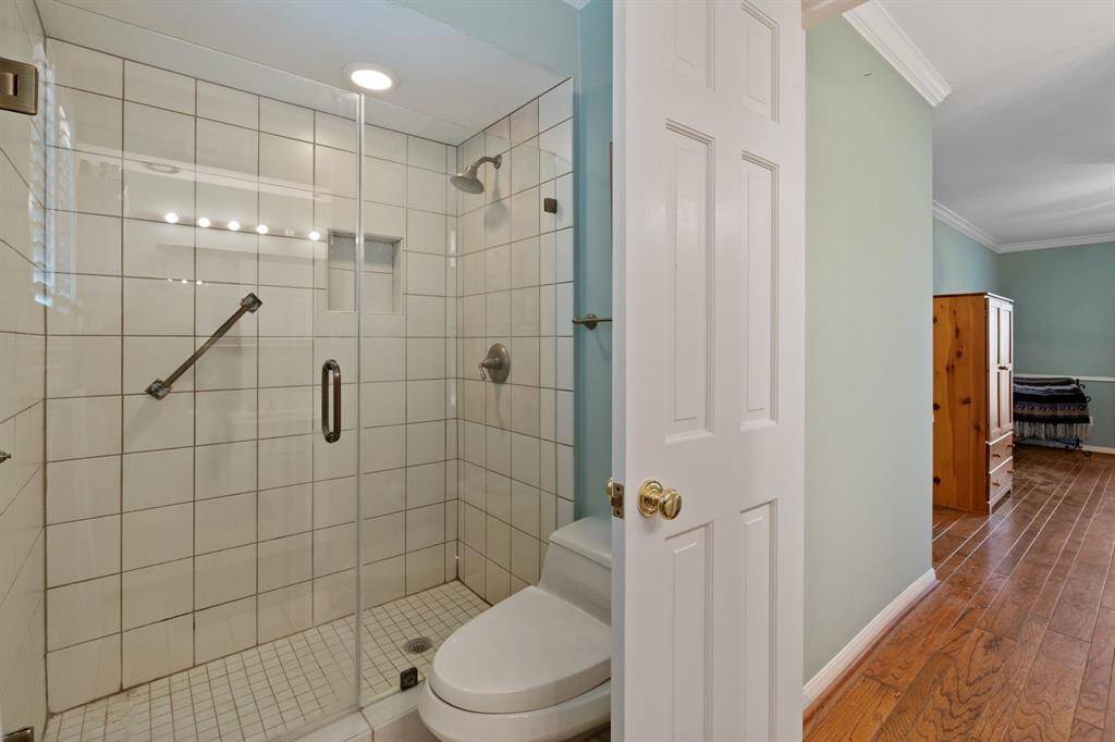 Walk-in shower with frameless glass.