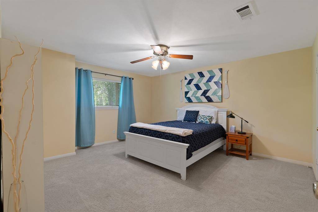 At the end of the hall is the fourth and final secondary bedroom. This room has a walk-in closet and overlooks the back yard.