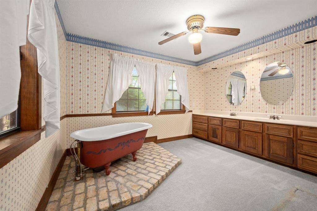 1 of the bathrooms that is next to hallway that leads to the living area on the left.