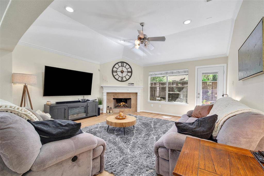 The living room overlooks the backyard and the windows bring in a great amount of natural light.