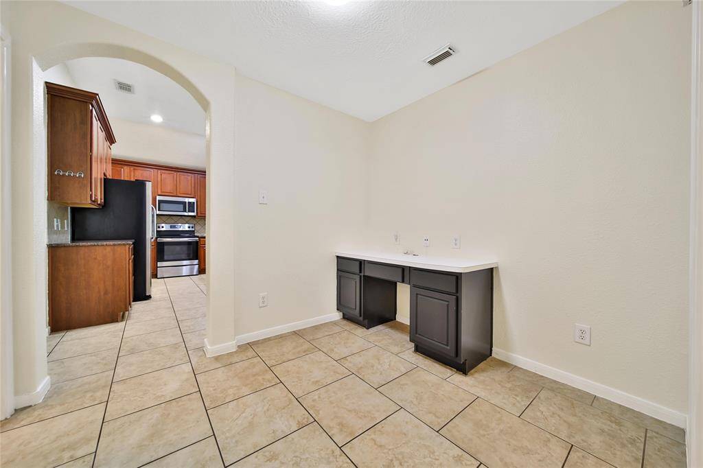 Right off of the kitchen is a flex space.  The built in desk is a great homework station that is right between the secondary bedrooms.