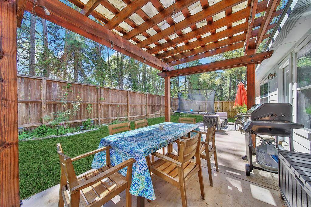 The backyard features a newly built cedar pergola and extended patio.