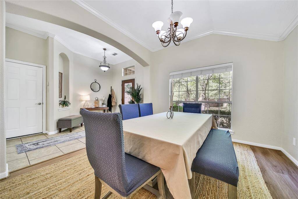 Immediately to your left as you enter is the formal dining room. This room is separated from the rest of the home and would also make a great home office, play room, or extra living space. The flooring in the dinging room is newly installed and is stunning!