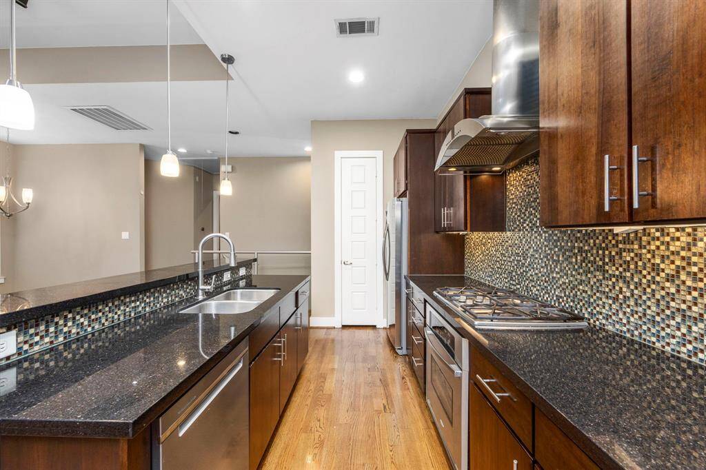 The kitchen features wood cabinets, creating a clean and timeless aesthetic.