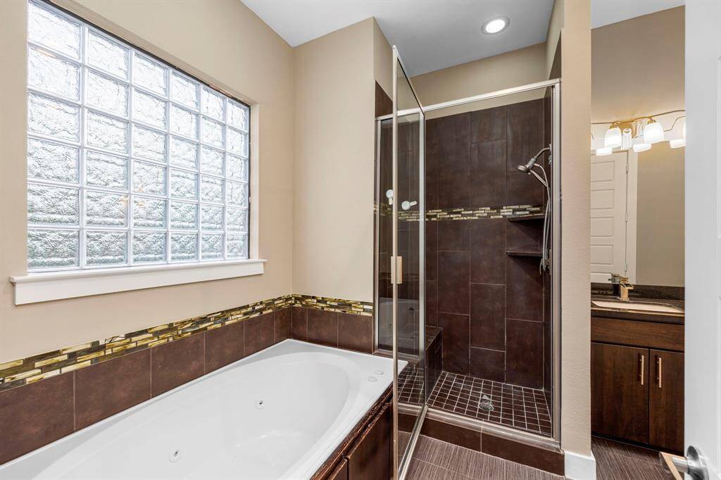 Soaking tub and Stand up shower in the primary bathroom.