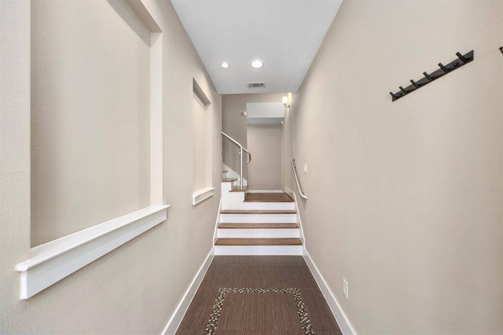 The entryway features custom paint and beautiful flooring leading to the second floor.