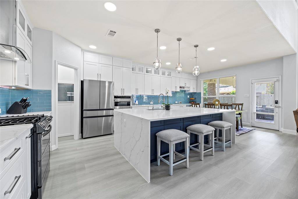 This fully remodeled kitchen has it all!  Custom cabinetry, soft close drawers, recessed lighting, under cabinet LED lighting, stunning quartz countertops with waterfall edge and updated appliances.