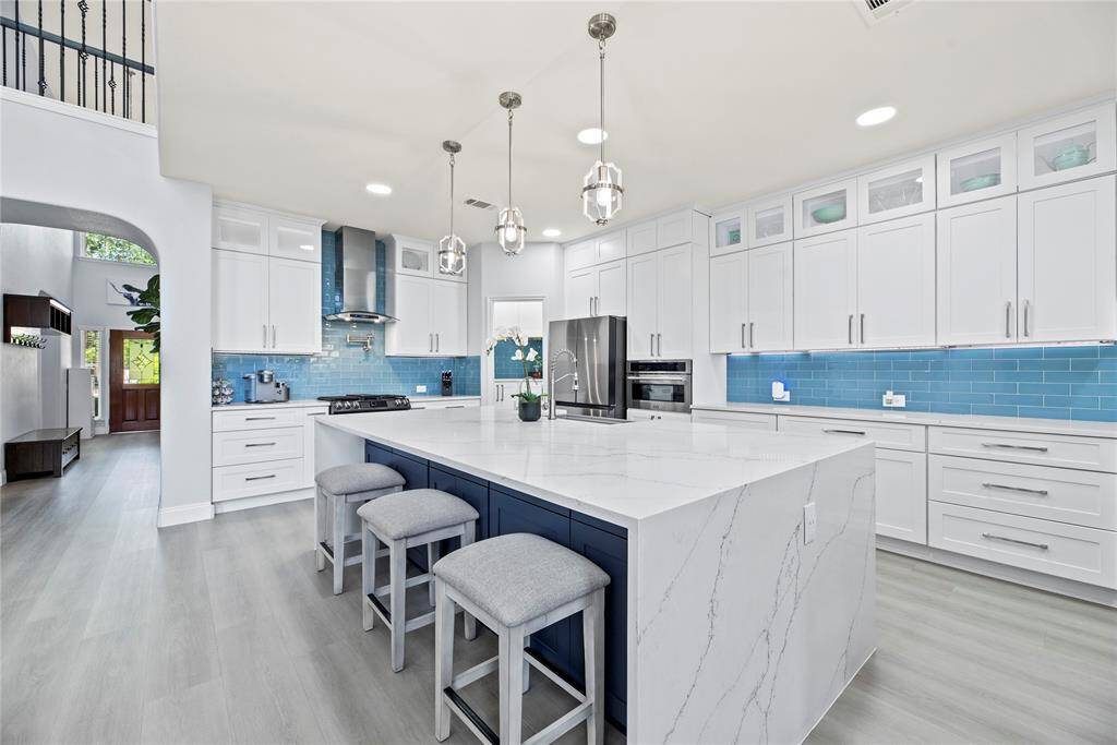 This bright, modern kitchen also features a breakfast bar with additional storage cabinets underneath!