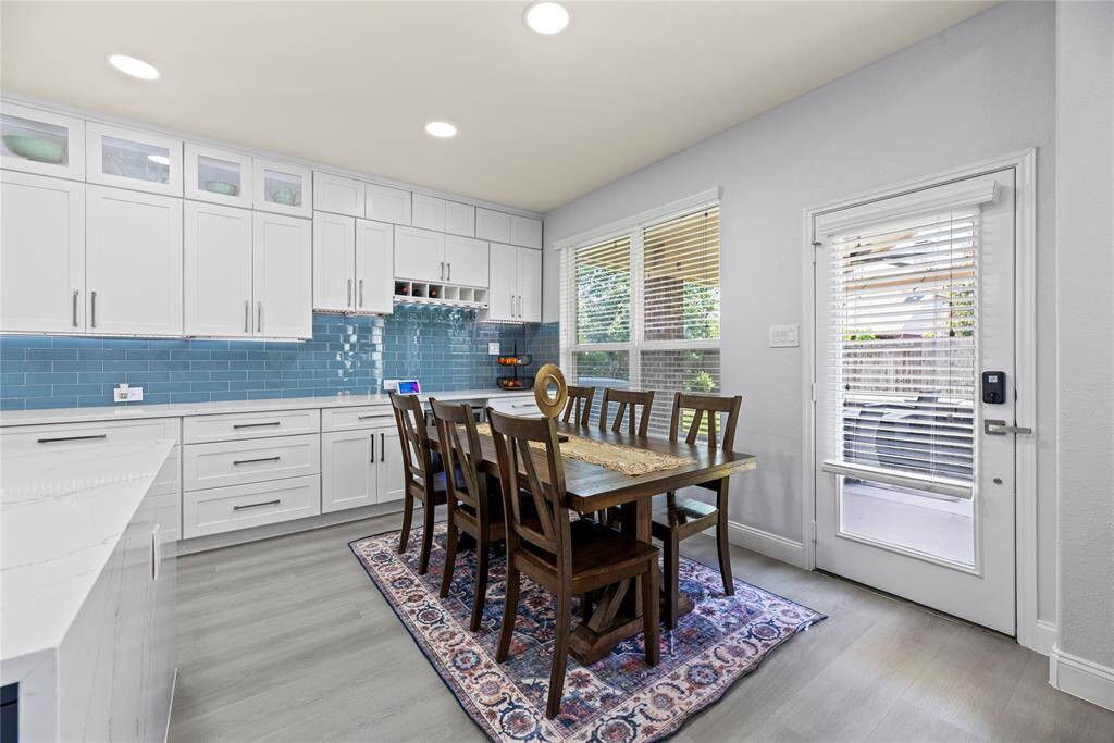 Generously sized breakfast area with more cabinets and a built in wine rack and wine refrigerator below.