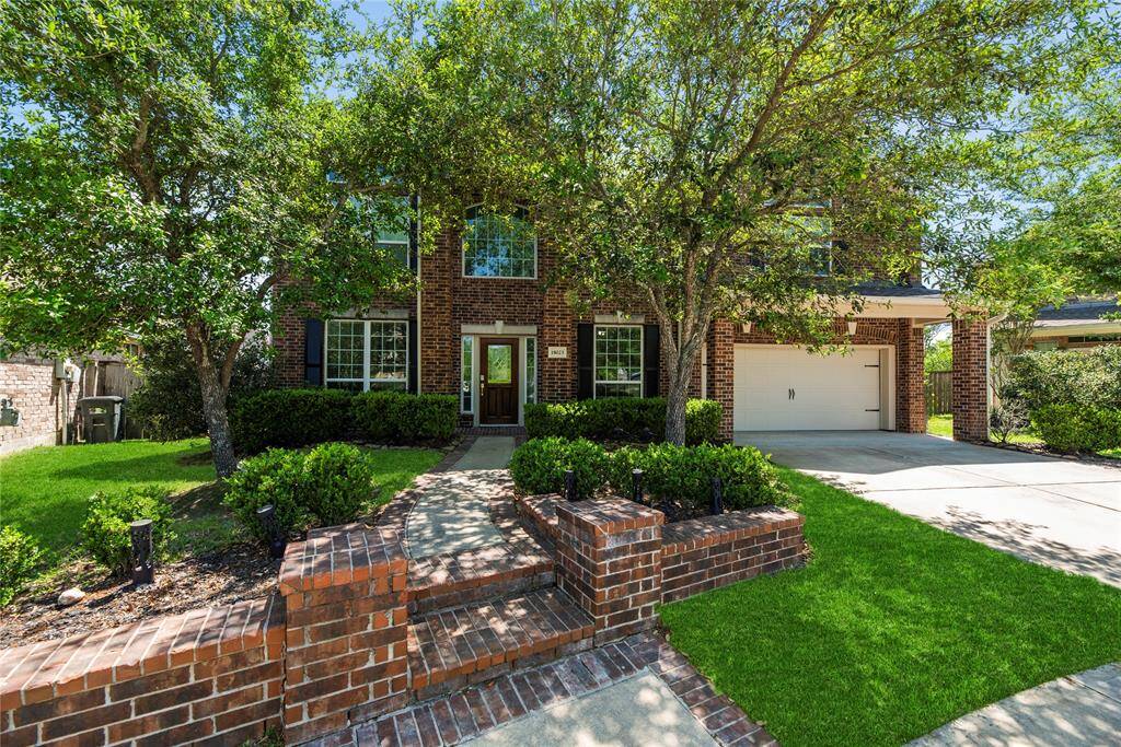 Stunning two-story brick home with charming curb appeal.