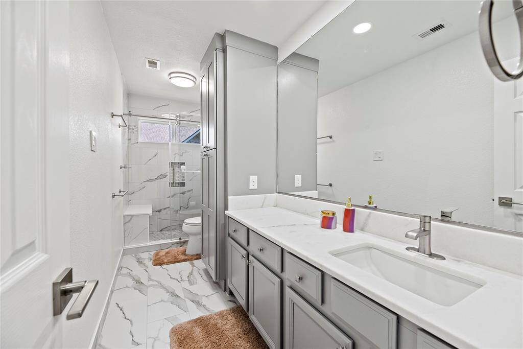 Second full bath upstairs.  Check out the abundance of cabinets!