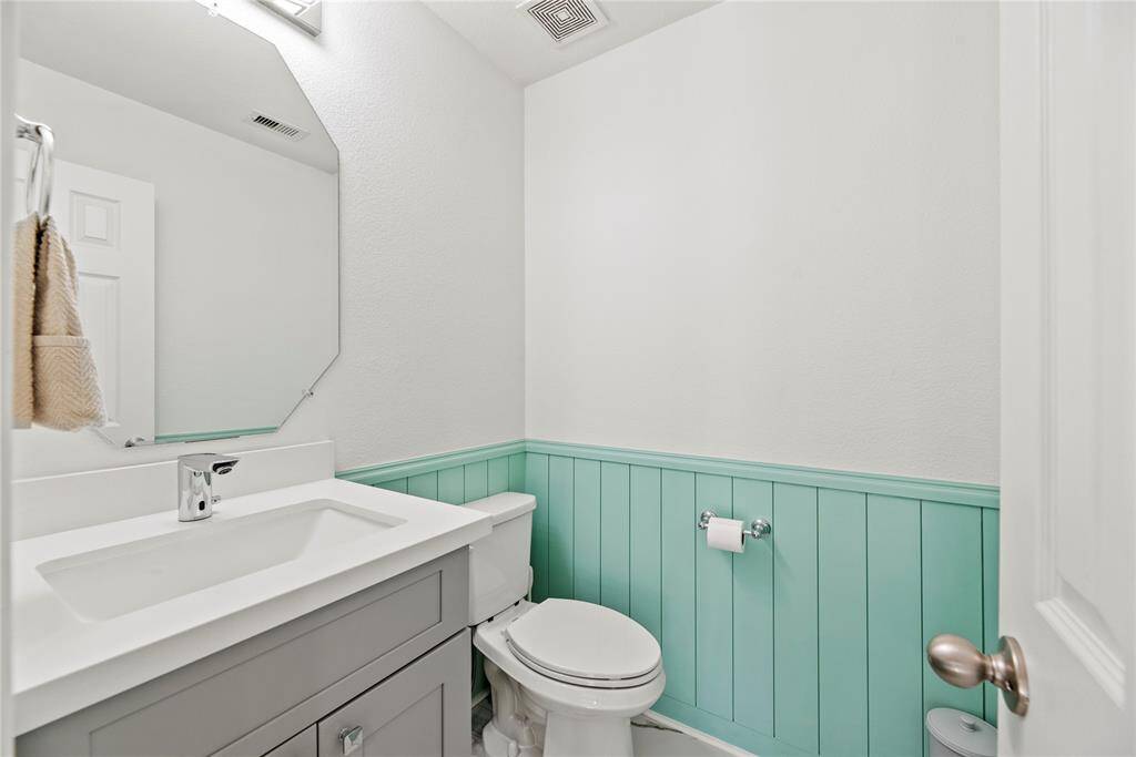 Super cute and convenient upstairs half bath.  Notice the custom board and batten paneling!