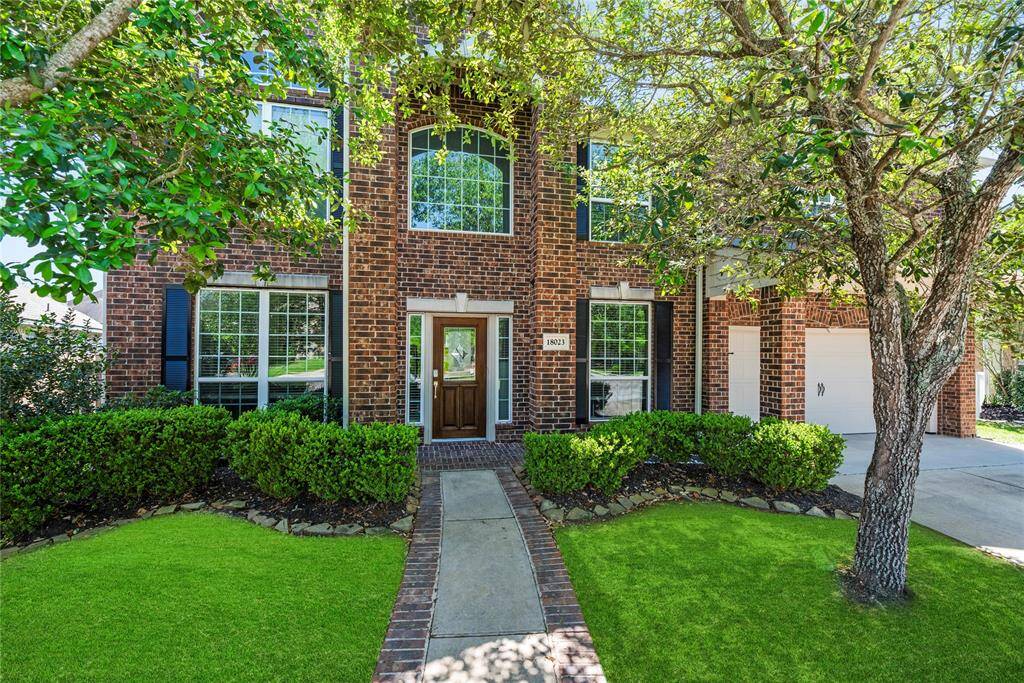 Mature trees and meticulously landscaped yard.