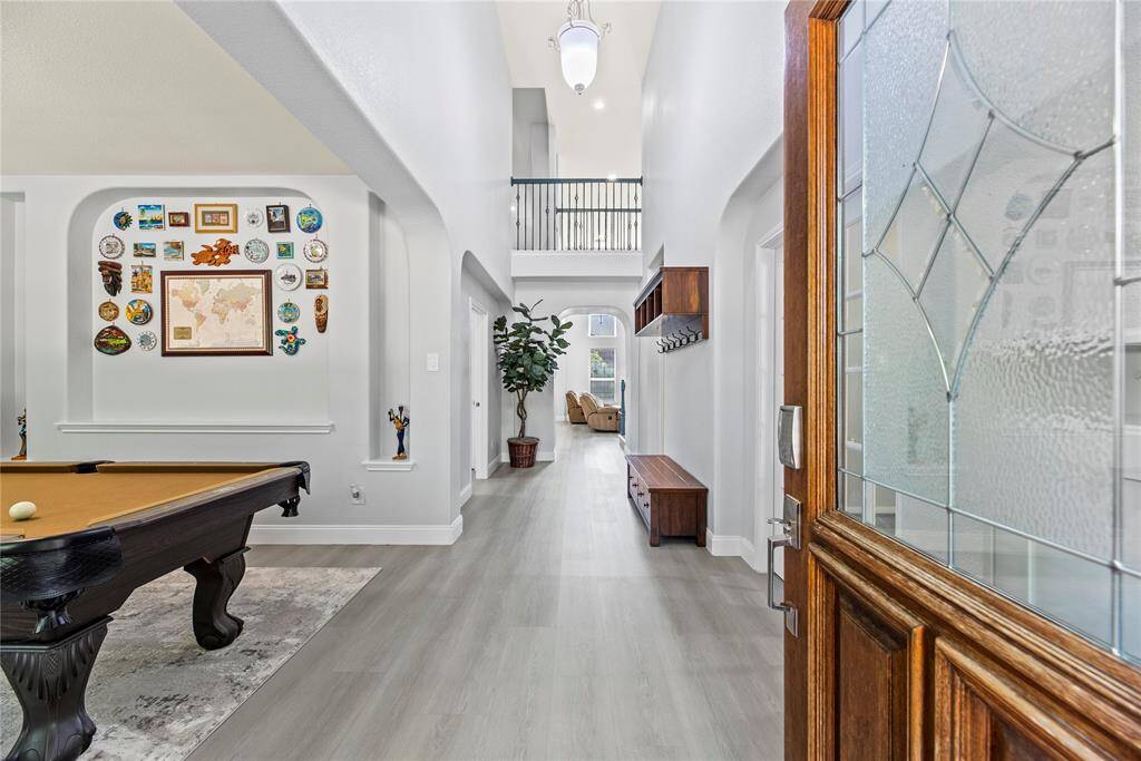 As you enter, you're greeted by gorgeous LVP flooring and soaring ceilings for a grand entrance.