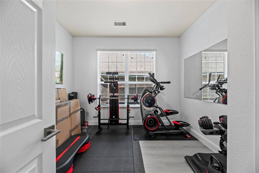 Secondary bedroom downstairs currently used as a workout room.