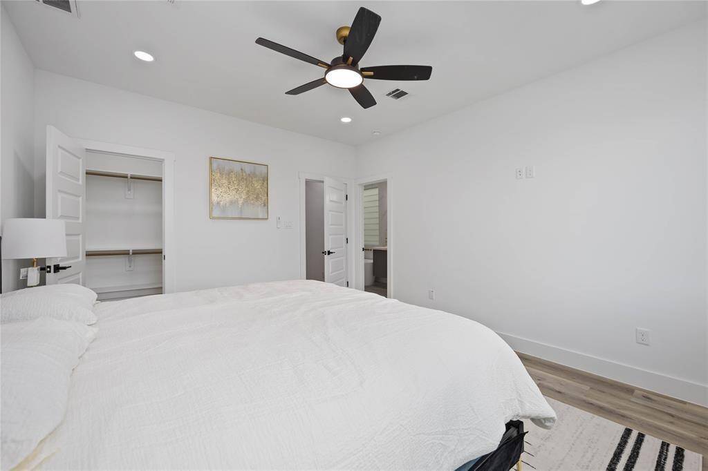 The door to the right leads to a luxurious ensuite bathroom. One of two closets for the suite is on the left.