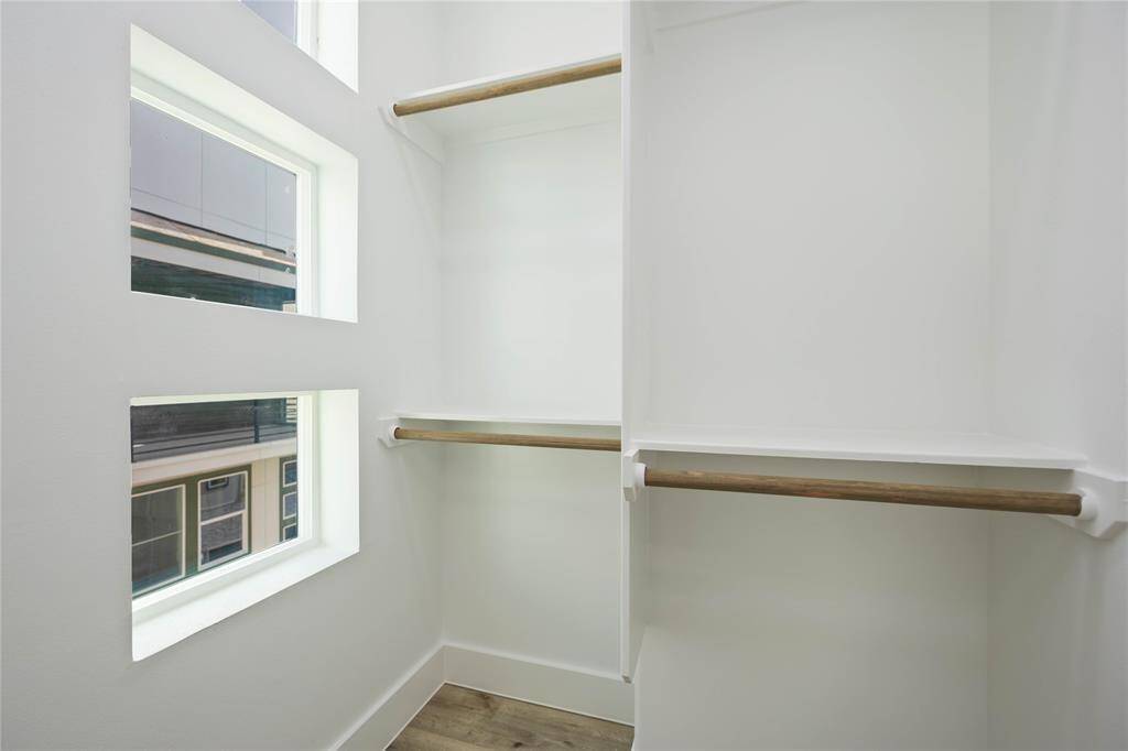 Beautiful windows bring in natural light into this walk-in closet.