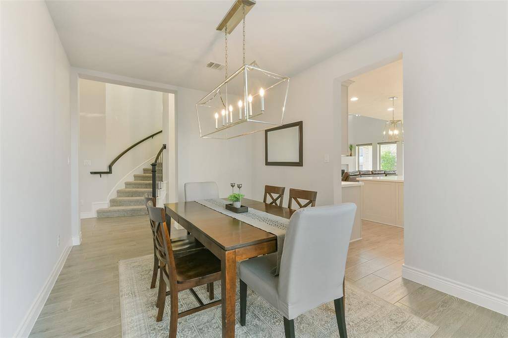 Formal dining is just off the entry with its curving staircase and the kitchen for ease of access.