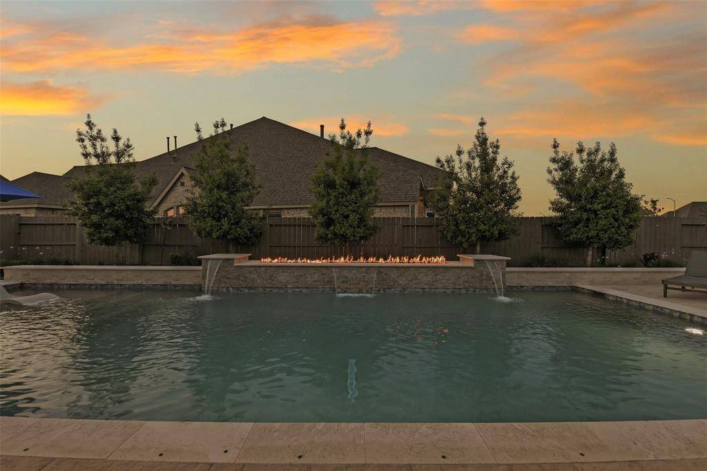 What a view! What a place to entertain or relax! Soothing waterfalls combine with the grand fire feature, all backed by professional landscaping.
