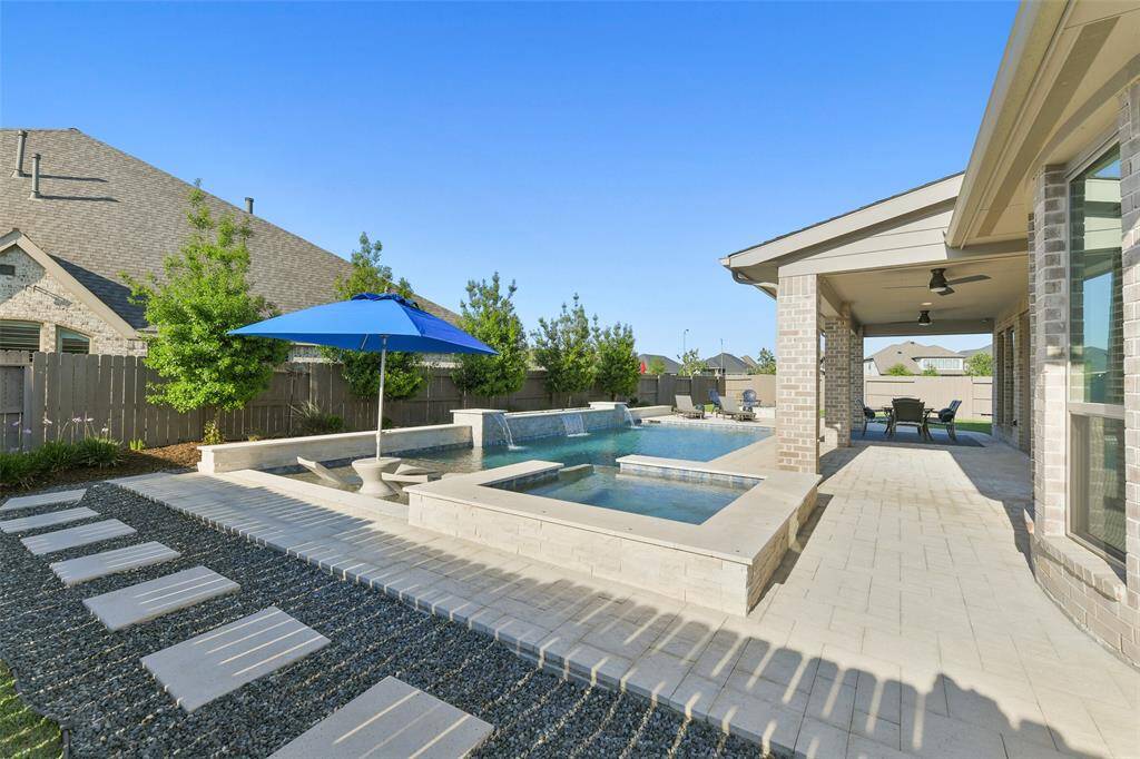 A wide paver path extends around the back and side of the pool for easy access to controls and landscaping. It also leads to where the Catch a Kid pool net is stored.