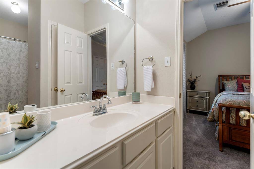 Jack-and-Jill bathroom offers convenience with private access to adjoining rooms.