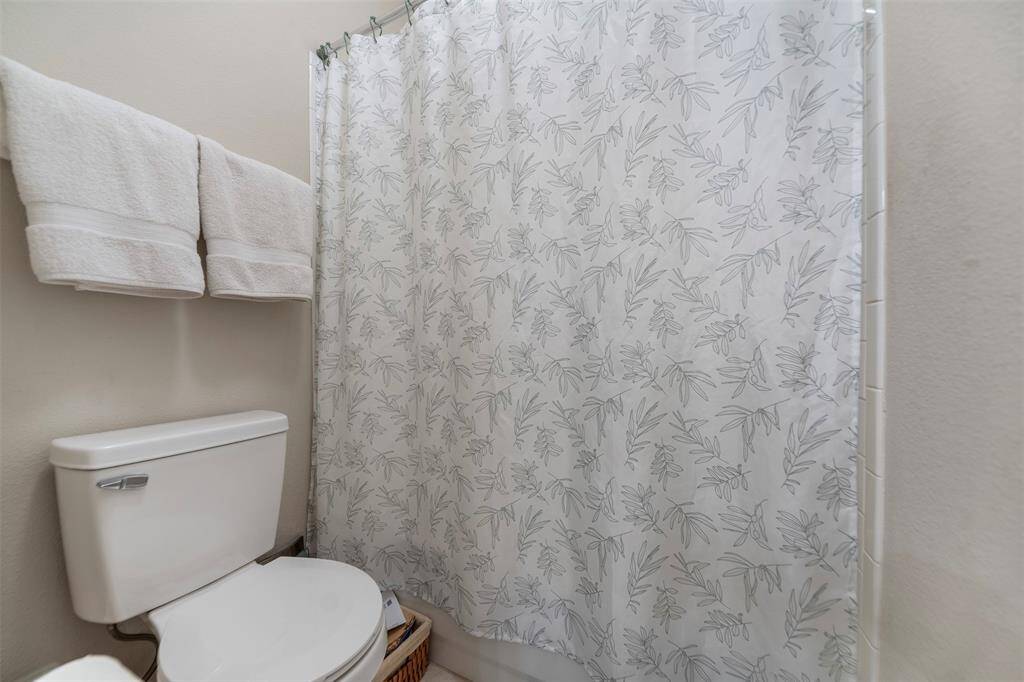 Separate shower and toilet area provides privacy and functionality.