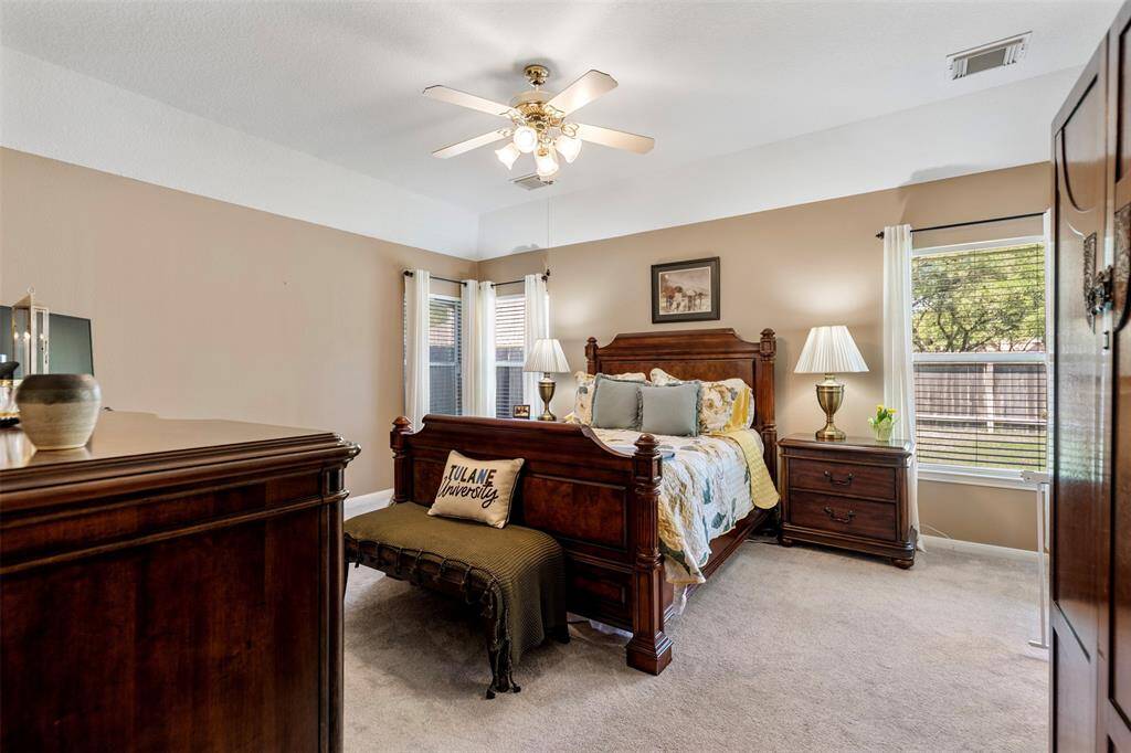 Spacious primary bedroom with large windows and plenty of natural light.