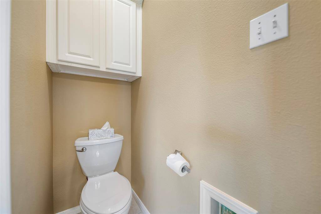 Private toilet area within the primary suite includes overhead storage.