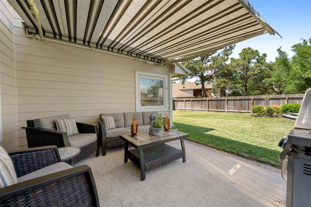 Imagine yourself enjoying conversations with family and friends in the shaded backyard.