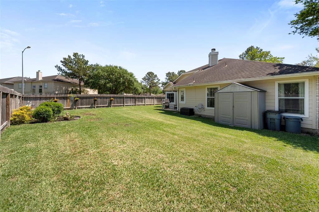 Spacious backyard with storage shed and room for outdoor activities.