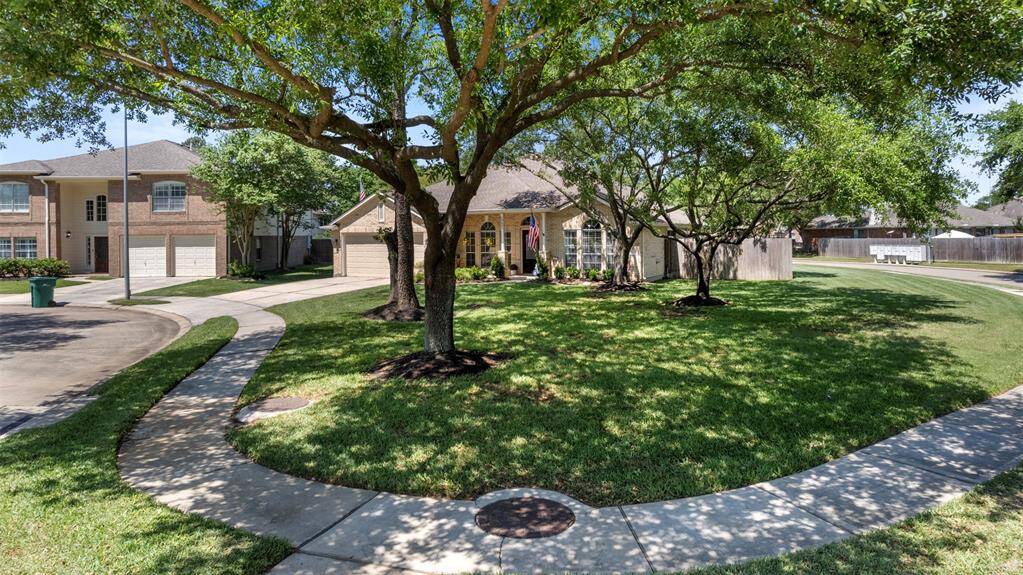 Tree-lined sidewalk wraps around this beautifully situated corner lot.