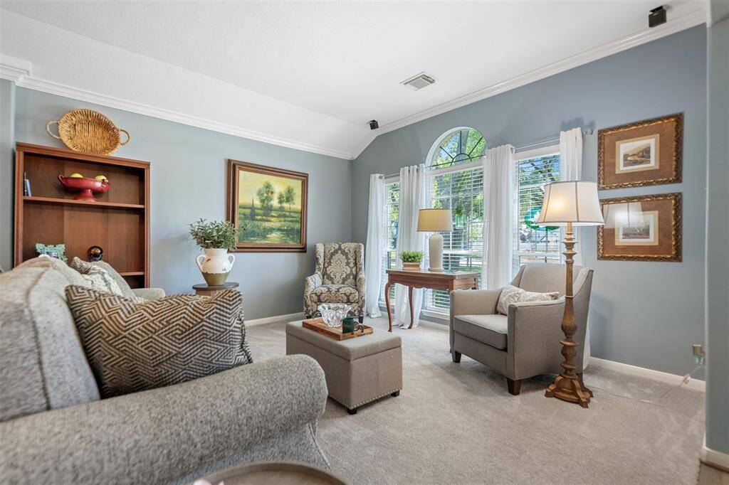 Large windows fill this living area with natural light, creating a perfect space for relaxing or all of your family gatherings.