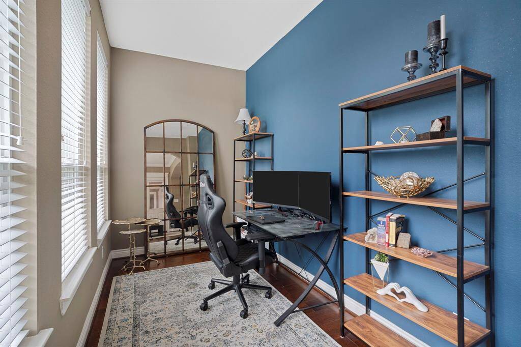 Also in the primary bedroom, a private and light-filled workspace with custom accent wall and designer lighting—perfect for remote work or creative inspiration.