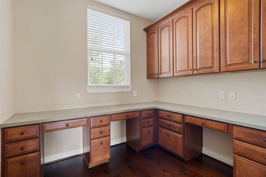 Versatile built-in workspace with extensive cabinetry and desk areas—ideal for homework, crafting, or a home office.