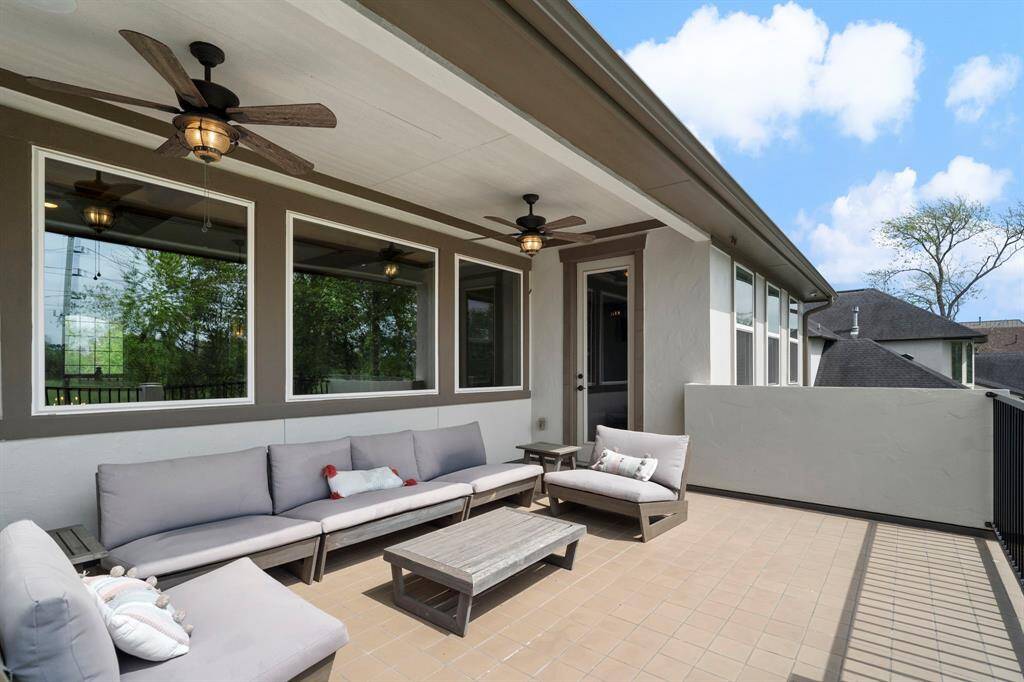 Enjoy breezy evenings on the covered upstairs balcony with ceiling fans—an entertainer’s dream.