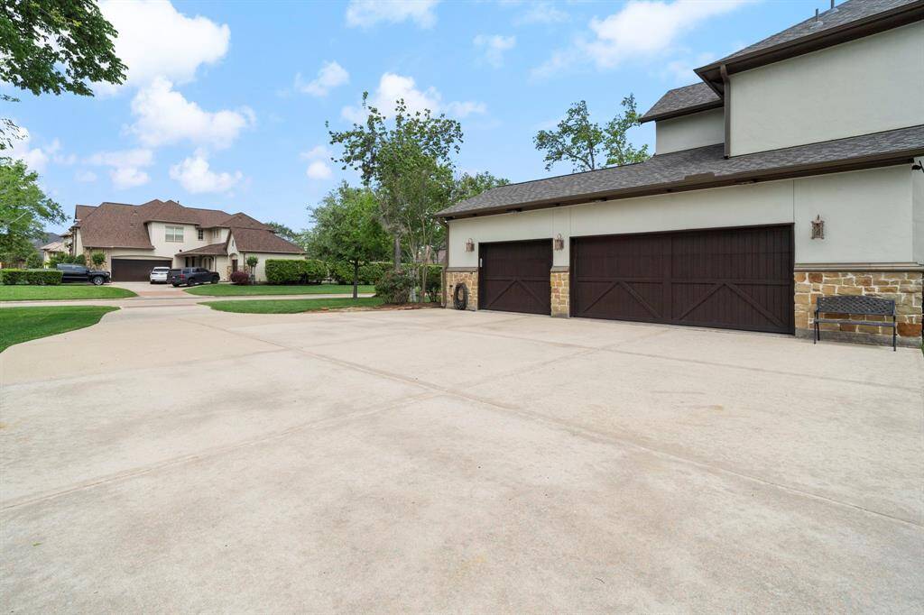 3-car garage with extended driveway allows for additional parking & sports court area.