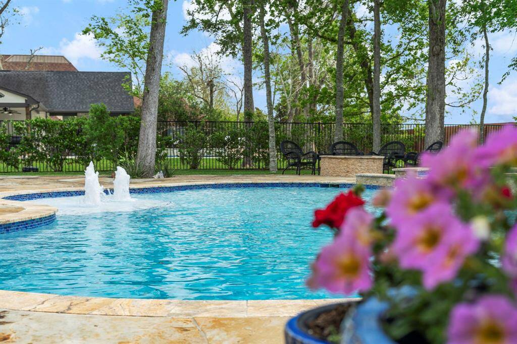 Relax beside the tranquil sounds of water features in this beautifully landscaped backyard retreat.