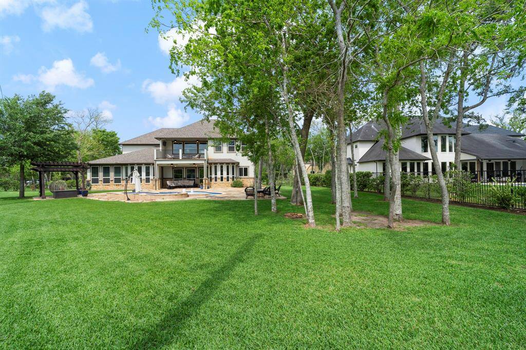 Expansive, beautifully manicured backyard offers ample space for entertaining, play, or simply soaking in the serenity of your own private retreat.