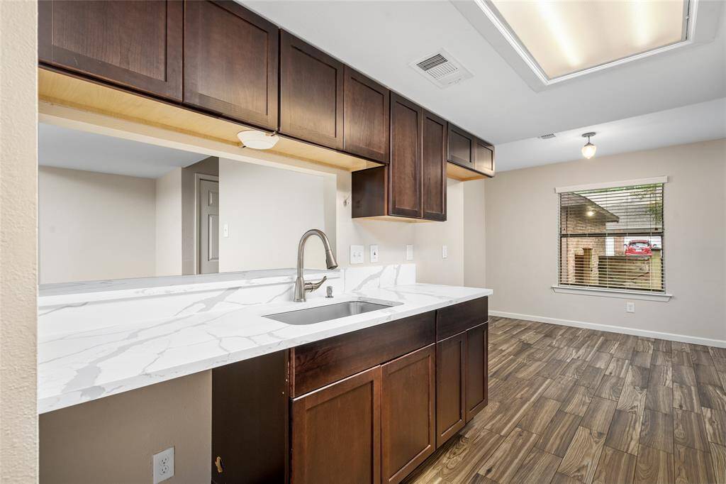 The pass through bar in the kitchen offers added access to your dining room for entertaining while a large window provides plenty of natural light.