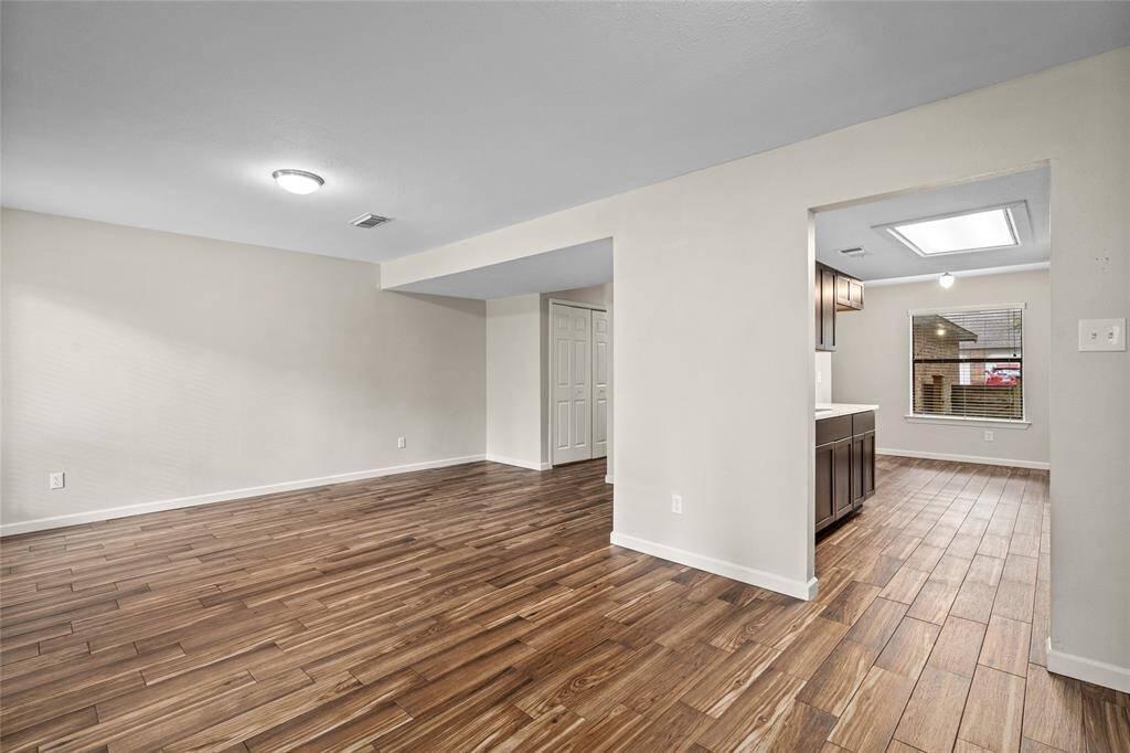 Your spacious, open-plan living area leading into a modern kitchen is a great space for entertaining.