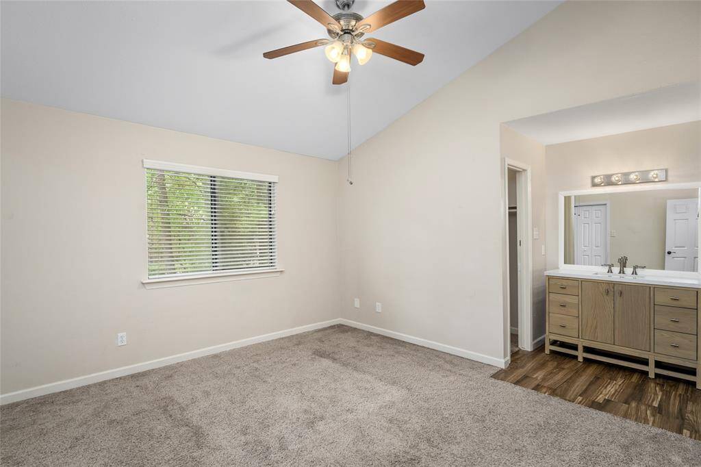 Another view of your new primary bedroom with an adjacent vanity area with tile flooring and a second closet, perfect for convenience.